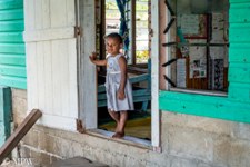 Fijian child at the doorwary to the school in the village